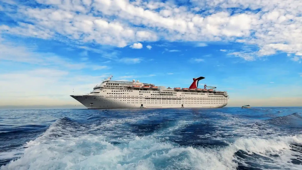 a cruise ship riding on water with a smaller boat riding behind it